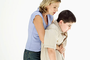 Image of an adult women giving the heimlich maneuver to a child who's choking. Image of an adult women giving the heimlich maneuver to a child who's choking.